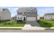 Beautiful new two-story home with a spacious lawn and a two-car garage at 174 Aster Avenue, Locust Grove, GA 30248