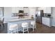 Bright kitchen boasts granite counters, stainless appliances, and an island with seating at 174 Aster Avenue, Locust Grove, GA 30248