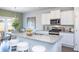 Well-lit kitchen area with white cabinetry, granite countertops, and stainless steel appliances at 174 Aster Avenue, Locust Grove, GA 30248