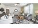 Inviting living room with a neutral color scheme, comfortable seating, and modern decor accents for a cozy atmosphere at 174 Aster Avenue, Locust Grove, GA 30248