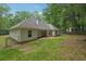 View of a fenced in backyard with a covered patio and view of the rear of the home at 25 Pebble Creek Dr, Covington, GA 30016