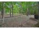 A fenced backyard with mature trees and a storage shed, creating a tranquil outdoor oasis at 25 Pebble Creek Dr, Covington, GA 30016