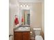 Compact bathroom features a single sink vanity, toilet, and mirror with good lighting, practical for everyday use at 25 Pebble Creek Dr, Covington, GA 30016