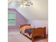 A bedroom with an attic ceiling, pink walls, a window, carpeted floors and a bed with orange bedding at 25 Pebble Creek Dr, Covington, GA 30016