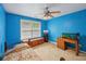 Well-lit bedroom with a ceiling fan and natural light; features an aquarium, adding a unique touch at 25 Pebble Creek Dr, Covington, GA 30016