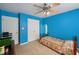 Blue bedroom with white doors, ceiling fan, and carpeted floor, offering a calm and comfortable feel at 25 Pebble Creek Dr, Covington, GA 30016