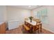Cozy dining area with a wood table, bench, tile floor, and natural light at 25 Pebble Creek Dr, Covington, GA 30016