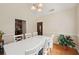 Bright dining room with white table set, hardwood floors, and stylish light fixture at 25 Pebble Creek Dr, Covington, GA 30016