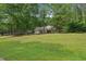 Well-kept home with mature trees and a large green front yard at 25 Pebble Creek Dr, Covington, GA 30016