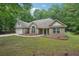 Lovely one-story brick home boasting an attached two-car garage and well-maintained front yard at 25 Pebble Creek Dr, Covington, GA 30016