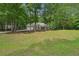 Well-kept home with mature trees and a large yard at 25 Pebble Creek Dr, Covington, GA 30016