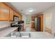 Bright kitchen with stainless appliances, light wood cabinets, and view into the dining area at 25 Pebble Creek Dr, Covington, GA 30016