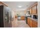 Well-lit kitchen with stainless steel appliances and a view into the adjacent dining room at 25 Pebble Creek Dr, Covington, GA 30016