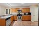 Bright kitchen with stainless steel appliances, wooden cabinets, and generous counter space at 25 Pebble Creek Dr, Covington, GA 30016