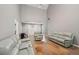 Bright living room featuring vaulted ceilings, hardwood floors, and leather couches at 25 Pebble Creek Dr, Covington, GA 30016