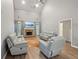 Bright and airy living room boasts a fireplace, vaulted ceilings, and hardwood floors at 25 Pebble Creek Dr, Covington, GA 30016