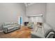 Bright living room featuring vaulted ceilings, hardwood floors, and leather couches at 25 Pebble Creek Dr, Covington, GA 30016