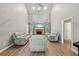 Bright and airy living room features a fireplace, vaulted ceilings, and hardwood floors at 25 Pebble Creek Dr, Covington, GA 30016