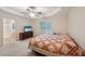 Relaxing main bedroom features a ceiling fan, neutral walls, and view of a connected bath at 25 Pebble Creek Dr, Covington, GA 30016