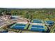 Aerial view showcasing tennis courts, pool and clubhouse among lush green surroundings at 2665 Crowbrook Way, Cumming, GA 30040
