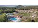 Aerial view of a community showcasing a pool, clubhouse, playground and lush greenery at 2665 Crowbrook Way, Cumming, GA 30040