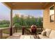 Relaxing covered back deck offers outdoor seating, a grill, and views of the private backyard at 2665 Crowbrook Way, Cumming, GA 30040