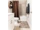 Cozy bathroom with brown shower curtain, modern vanity, and a neutral color scheme at 2665 Crowbrook Way, Cumming, GA 30040