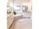 Modern bathroom featuring a soaking tub, dual vanities, and neutral color palette at 2665 Crowbrook Way, Cumming, GA 30040
