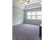 Spacious bedroom with tray ceilings, large windows, and carpeted floors at 2665 Crowbrook Way, Cumming, GA 30040