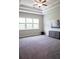 Spacious bedroom with tray ceilings, large windows, and carpeted floors at 2665 Crowbrook Way, Cumming, GA 30040