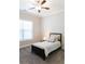 Neutral bedroom featuring a ceiling fan, a large window, and carpet at 2665 Crowbrook Way, Cumming, GA 30040