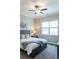 Cozy bedroom with grey walls, a ceiling fan, and a large window providing natural light at 2665 Crowbrook Way, Cumming, GA 30040
