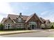 Exterior shot of a grand clubhouse with stone accents, a welcoming entrance, and manicured landscaping at 2665 Crowbrook Way, Cumming, GA 30040