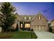 Charming brick home featuring a manicured lawn, dormer windows, and a spacious two-car garage at 2665 Crowbrook Way, Cumming, GA 30040