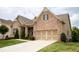 Lovely brick home featuring an attached two-car garage and a manicured lawn at 2665 Crowbrook Way, Cumming, GA 30040