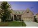 Beautiful brick home featuring manicured lawn, dormers, and an attached two car garage at 2665 Crowbrook Way, Cumming, GA 30040