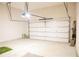 Spacious garage with an automatic door, ample storage space, and concrete flooring at 2665 Crowbrook Way, Cumming, GA 30040