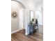 Welcoming hallway with beautiful wood floors, arched doorways and a console table at 2665 Crowbrook Way, Cumming, GA 30040
