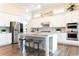 Modern kitchen with white cabinets, stainless steel appliances, granite countertops, and wood floors at 2665 Crowbrook Way, Cumming, GA 30040