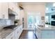 Kitchen with stainless steel appliances, granite countertops and door to the backyard at 2665 Crowbrook Way, Cumming, GA 30040
