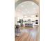 Open-concept kitchen boasts white cabinets, stainless steel appliances, and a large island at 2665 Crowbrook Way, Cumming, GA 30040