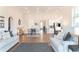 Open-concept living room and kitchen with an eating area, and neutral-toned furniture at 2665 Crowbrook Way, Cumming, GA 30040