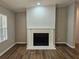 Elegant fireplace with a decorative mantle and hearth, complemented by hardwood floors and neutral walls at 85 Holly Dr, Carrollton, GA 30116