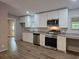 Bright kitchen features white cabinets, granite countertops, and stainless steel appliances at 85 Holly Dr, Carrollton, GA 30116