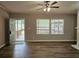 Bright living room with wood floors and a view of the covered porch through large windows at 85 Holly Dr, Carrollton, GA 30116