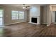 Living area with hardwood floors, fireplace, bright windows, and access to an outdoor space at 85 Holly Dr, Carrollton, GA 30116