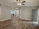 Open-concept living area with hardwood floors, neutral walls, and a view of the kitchen at 85 Holly Dr, Carrollton, GA 30116