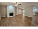 Spacious living room featuring hardwood floors, a decorative fireplace, and an open layout at 85 Holly Dr, Carrollton, GA 30116