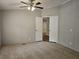 Spacious main bedroom with a ceiling fan and neutral carpeting at 85 Holly Dr, Carrollton, GA 30116