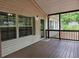 Covered porch with stained wood flooring and neutral siding offers a cozy outdoor seating area at 85 Holly Dr, Carrollton, GA 30116